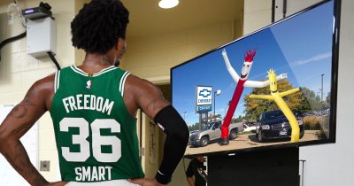 A determined Marcus Smart studies film of wavy arm inflatable guys before big game